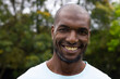 © Wavebreak Media - Smiling african american man enjoying nature outdoors, feeling happy and relaxed in park