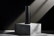 © AgungRikhi - A sleek black bottle on a textured concrete pedestal, illuminated by dramatic lighting.
