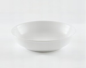 there is a white bowl sitting on a white surface.