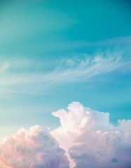 Wall Mural - Soft, fluffy clouds drift across a clear blue sky, creating a serene and tranquil scene.