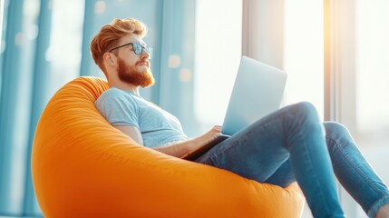 Sticker - A relaxed programmer lounging on a beanbag chair, reviewing code on a laptop while brainstorming solutions in a casual office environment.