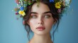 © ProPhotos - Close-up of a gorgeous woman with a vibrant, romantic flower crown capturing her youthful radiance and elegance against a light blue background.
