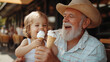 © Sawyer0 - W kawiarni na świeżym powietrzu dziadek i wnuk cieszą się wspólnym czasem, delektując się lodami.