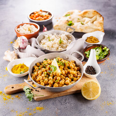 Wall Mural - indian naan bread, chickpea curry, rice and spices