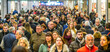 © Nadezhda - Early bird shoppers in a festive mood eagerly browsing products against a bustling Black Friday background.