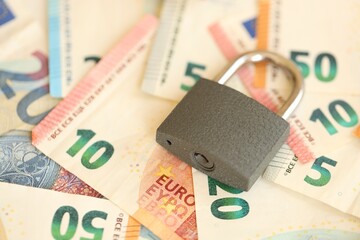 Wall Mural - Euro banknotes with lock on wooden table background