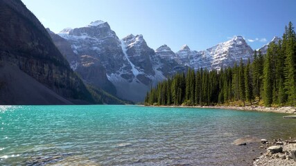 Wall Mural - Moraine lake nature scenery in autumn sunny day. Sparkle turquoise blue water, snow-covered Valley of the Ten Peaks. Banff National Park, Canadian Rockies, Alberta, Canada.