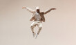 © Surachetsh - A man in casual beige and white performs a dynamic dance move, set against a neutral background, showcasing freedom and the essence of street style.