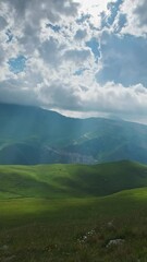 Wall Mural - beautiful mountain landscape with sun rays and clouds, timelapse. vertical video