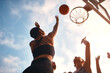 © peopleimages.com - Shoot, basketball and women with ball, sport and practice for game, outdoor and training for match and fitness. Air, friends and low angle for competition or bonding together for teamwork and campus