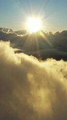 Wall Mural - flying above the clouds. aerial view of clouds and morning sun. traveling by air perfect background.