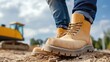 © Moopingz - Close-up of rugged work boots in a construction site environment, symbolizing safety, durability, and industrial work.