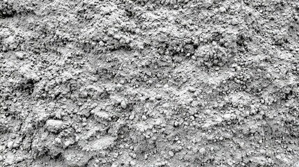 Aufkleber - A close-up of packed, dry soil displaying various granular textures in a natural, outdoor environment illuminated by bright daylight, highlighting its unique composition