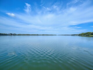 A serene lake reflecting the surrounding trees and sky, reflection, nature