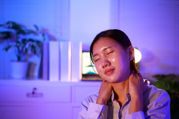 Asian woman diligently works overtime, managing a heavy workload with focus and determination. Despite the challenges, her commitment shines through as she strives  and meets her deadlines.