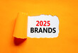 © Dzmitry - Planning 2025 brands new year symbol. Concept words 2025 Brands on beautiful white paper. Beautiful orange paper background. Business 2025 brands new year concept. Copy space.