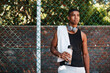 © peopleimages.com - Basketball, player or man with water on break at sports court for game training and thinking of tournament match. Hobby, athlete or resting with headphones for competition workout or fitness practice