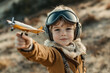 © romanets_v - Young aviator boy with toy airplane and goggles in outdoor adventure setting