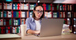 © Andrey Popov - University Student In Library With Laptop