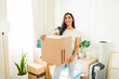 © AntonioDiaz - Happy woman unboxing a package in her new living room
