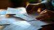 © nimaxs - Warmly lit close-up of hands reviewing financial documents with property loan paperwork, budget breakdowns, and a credit score report, capturing the details of loan preparation