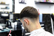 © Olga Mukashev - Men's haircut in a barbershop or beauty salon. Hairdressing services in a barbershop.