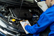 © zphoto83 - Automotive technician inspecting engine components during a maintenance check in a repair shop on a busy weekday afternoon