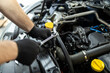 © zphoto83 - Mechanic working on an engine with tools in a workshop during daytime, focusing on maintenance and repairs