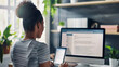 © mahamad - Phone, Computer Screen and Woman Typing - A woman typing on a computer and phone, involved in online networking and marketing.