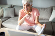 © Marko Geber - Senior woman working on laptop at home