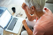 © Marko Geber - Senior woman working on laptop at home