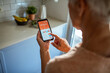 © Marko Geber - Senior woman tracking workout progress on fitness app