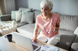 © Marko Geber - Senior woman working on laptop at home