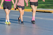 © Zkidstock - Legs of three unrecognizable women walking outdoors in sportswear on a sunny day