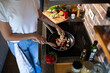 © Geber86 - Young woman cooking healthy vegetables in modern kitchen