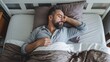 © Jasper - Middle Aged Man Sleeps Peacefully in Bed. Time to rest and nap concept. top view