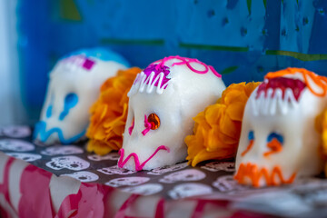 Three decorated sugar skulls, which are a traditional element of the Day of the Dead, in Spanish: 