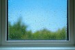 © Сергей Захаров - Raindrops on windowpane with blurred greenery in background