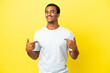 © luismolinero - African American handsome man on isolated yellow background proud and self-satisfied