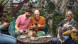 © Lomb - Young diverse friends using smartphones while relaxing in hostel terrace - modern lifestyle concept