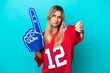 © luismolinero - Uruguayan sports fan woman isolated on blue background showing thumb down with negative expression