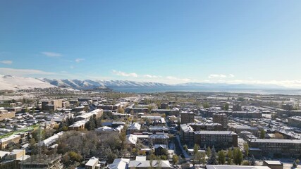 Wall Mural - Aerial rising view Sevan town and Lake Sevan. Famous Sevan lake - large, high-altitude lake in eastern Armenia. Winter travel visit destination Armenia concept.