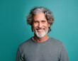 © Ranta Images - Portrait of Handsome Mature Man Looking Happy and Smiling Against Colored Studio Background