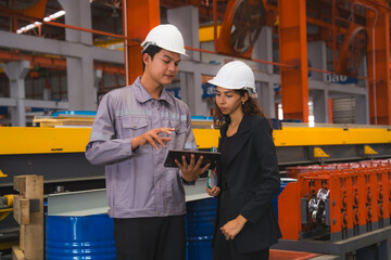 A female expertise engineering manager or inspector and Mechanic or technician are checking or examining the quality of metal sheet machine of industry, manufacturing or factory, Business successful.