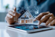 © Quality One   - person analyzing mortgage rates and property data on tablet, showcasing 3D house model with graphs and charts. scene reflects modern technology in real estate