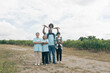 © Wassana - A biracial family standing in front of a wind farm and looks at the view from above. The daughter rides on the shoulders of her black father.