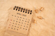 © Southtownboy Studio - April 2025 desk calendar with wooden thumbtack on brown crumpled paper background.