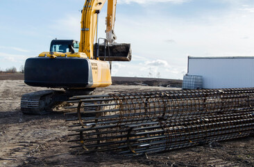 Building activity on contruction site.Drilling machine.Wind turbine construction.
Excavator and other construction equipment.