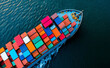 © Curioso.Photography - A cargo ship loaded with colorful containers docked at a port, next to large red cranes under a clear sky.