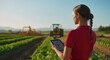 © Eugen - Male farmer using a tablet in a field with tractors in the background, symbolizing the integration of technology in crop management and efficient farming practices.